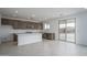 Bright modern kitchen with stainless steel appliances and center island open to adjacent room at 21291 W Edgemont Ave, Buckeye, AZ 85396