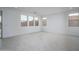 Spacious living area with tile floors and abundant natural light from large windows at 21291 W Edgemont Ave, Buckeye, AZ 85396