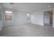 Large living area with tile flooring, neutral paint, and expansive windows for natural light at 21291 W Edgemont Ave, Buckeye, AZ 85396