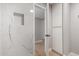 Modern bathroom with marble look tile, built in shelf and linen closet at 2157 N Recker Rd, Mesa, AZ 85215