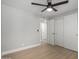 Bright bedroom featuring a ceiling fan, wood floors, and closet with sliding doors at 2157 N Recker Rd, Mesa, AZ 85215