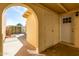Covered carport with access to a gated courtyard featuring an arched doorway at 2157 N Recker Rd, Mesa, AZ 85215