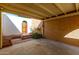 Covered carport with access to a gated courtyard featuring an arched doorway at 2157 N Recker Rd, Mesa, AZ 85215