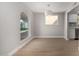 Sun-filled dining room features hardwood floors and views from a large arched window at 2157 N Recker Rd, Mesa, AZ 85215