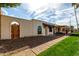 Charming home featuring a desert landscape and an arched gated front door at 2157 N Recker Rd, Mesa, AZ 85215
