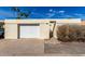 Detached garage with white door provides private parking and additional storage space for the residence at 2157 N Recker Rd, Mesa, AZ 85215