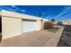 Detached garage is set back from the street and has a white door, offering private parking space at 2157 N Recker Rd, Mesa, AZ 85215
