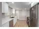 A modern kitchen with stainless steel appliances, white cabinets, and quartz countertops at 2157 N Recker Rd, Mesa, AZ 85215