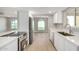 Bright, updated kitchen with white countertops and stainless steel appliances and view to yard at 2157 N Recker Rd, Mesa, AZ 85215