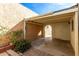 Relaxing covered patio area with lush greenery and access to a private outdoor space at 2157 N Recker Rd, Mesa, AZ 85215