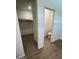 Bright bathroom with white fixtures next to walk-in closet featuring carpet flooring and closet organizers at 25372 W Sunland Ave, Buckeye, AZ 85326