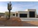Stunning modern home featuring desert landscaping, a spacious driveway and three-car garage at 29022 N 166Th Ave, Surprise, AZ 85387