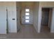 Hallway view showcasing a modern front door with glass panels, and neutral-toned tile flooring at 29022 N 166Th Ave, Surprise, AZ 85387