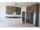Spacious kitchen with ample cabinet space and a large island under construction at 29022 N 166Th Ave, Surprise, AZ 85387