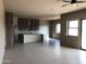 Open floor plan with modern kitchen, recessed lighting, ceiling fan and large windows at 29022 N 166Th Ave, Surprise, AZ 85387
