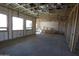 Unfinished living room showcasing exposed framing, insulation, and large windows for ample natural light, ready for customization at 29022 N 166Th Ave, Surprise, AZ 85387