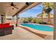 Backyard swimming pool with covered patio, seating, and mature landscaping at 3099 E Runaway Bay Pl, Chandler, AZ 85249