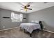 Cozy bedroom with carpet, ceiling fan, and natural light from the window at 3099 E Runaway Bay Pl, Chandler, AZ 85249