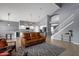 Spacious open-concept living room with a view of the modern kitchen and staircase at 3099 E Runaway Bay Pl, Chandler, AZ 85249