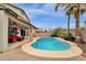 Backyard pool with waterfall feature, patio seating, and mature landscaping at 3099 E Runaway Bay Pl, Chandler, AZ 85249