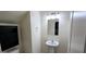 Small bathroom with pedestal sink, built in cabinet, and simple lighting at 3113 E Danbury Rd # 5, Phoenix, AZ 85032