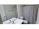 Bright bathroom featuring a large mirror, white sink, and a floral shower curtain at 3113 E Danbury Rd # 5, Phoenix, AZ 85032