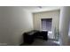 Bedroom with neutral carpet, dark desk, and a shelf next to the window at 3113 E Danbury Rd # 5, Phoenix, AZ 85032