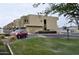 Modern townhomes with well-maintained landscaping, green grass, and a red car parked nearby at 3113 E Danbury Rd # 5, Phoenix, AZ 85032