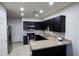 Kitchen featuring stainless steel appliances, dark cabinets, and granite countertops at 3113 E Danbury Rd # 5, Phoenix, AZ 85032