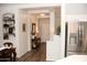 Inviting entryway with wood floors, neutral walls, an entry table, and stainless steel refrigerator at 3701 S Wickiup Rd, Apache Junction, AZ 85119