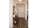 Entryway with wood floors, a side table with a lamp, and a white front door at 3701 S Wickiup Rd, Apache Junction, AZ 85119