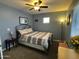 Comfortable bedroom with light-blue walls, ceiling fan, and carpet flooring at 3937 E Rosemonte Dr, Phoenix, AZ 85050