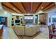 Comfortable living room featuring a stone fireplace, wooden beam ceiling, built in shelves and mountain views at 39424 N Spur Cross Rd, Cave Creek, AZ 85331