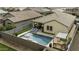 Aerial view of backyard featuring a pool, patio, and lounging area at 41262 W Almira Dr, Maricopa, AZ 85138