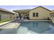 Inviting backyard oasis with a pool, hot tub, and covered patio for relaxation at 41262 W Almira Dr, Maricopa, AZ 85138