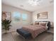 A bright bedroom with neutral walls, a patterned rug and cozy decor at 41262 W Almira Dr, Maricopa, AZ 85138