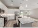 Modern kitchen with white cabinets, stainless steel appliances, and a large island at 41262 W Almira Dr, Maricopa, AZ 85138