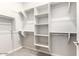 Spacious walk-in closet with custom shelving and ample storage space for organization at 41262 W Almira Dr, Maricopa, AZ 85138