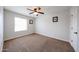 Empty bedroom with carpet, ceiling fan, and natural light from the window at 4202 E San Gabriel Ave, Phoenix, AZ 85044