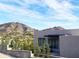 Modern home's exterior showcasing clean lines, complemented by the Arizona landscape and blue sky at 4232 E Upper Ridge Way, Paradise Valley, AZ 85253