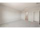 Empty bedroom with light-colored walls and carpet, adjacent to the bathroom at 42860 W Palo Abeto Dr, Maricopa, AZ 85138