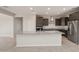 Modern kitchen with granite countertops, stainless steel appliances, and ample cabinet space at 42860 W Palo Abeto Dr, Maricopa, AZ 85138