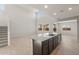 Spacious kitchen island featuring granite countertops, stainless sink, and dark wood cabinets at 42860 W Palo Abeto Dr, Maricopa, AZ 85138