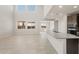 Open-concept living space with kitchen island, large windows, and plenty of natural light at 42860 W Palo Abeto Dr, Maricopa, AZ 85138