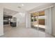 Open floor plan with spacious living area, kitchen, and access to the backyard patio at 42860 W Palo Abeto Dr, Maricopa, AZ 85138
