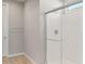 Bathroom with a white tiled shower, tile floors, and bright lighting at 42965 W Palo Abeto Dr, Maricopa, AZ 85138