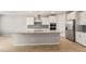 Bright kitchen features a large island, modern appliances, and stylish backsplash at 42965 W Palo Abeto Dr, Maricopa, AZ 85138