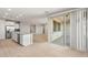 Open-concept living area with kitchen view and sliding doors to the exterior at 42965 W Palo Abeto Dr, Maricopa, AZ 85138
