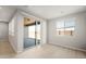 Bright room with sliding glass doors leading to a covered patio and an exterior block wall at 42965 W Palo Abeto Dr, Maricopa, AZ 85138
