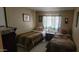 Bedroom features two twin beds and traditional decor with a dresser at 44 S Hawes Rd # C13, Mesa, AZ 85208